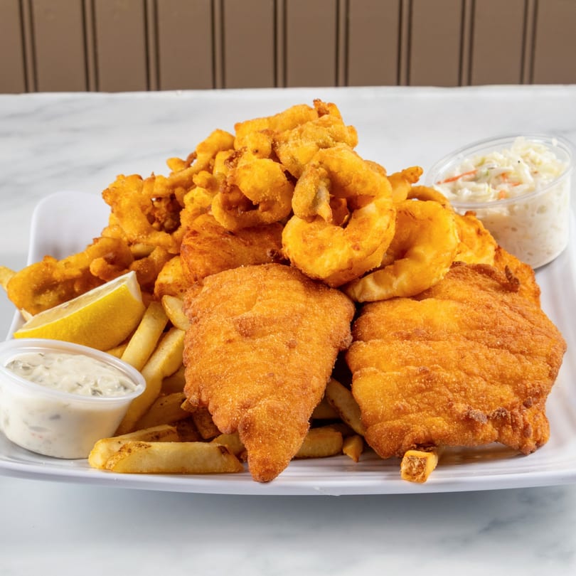 North End Market & Deli's fried seafood platter with fish, clams, fries, coleslaw, tartar sauce, and lemon.