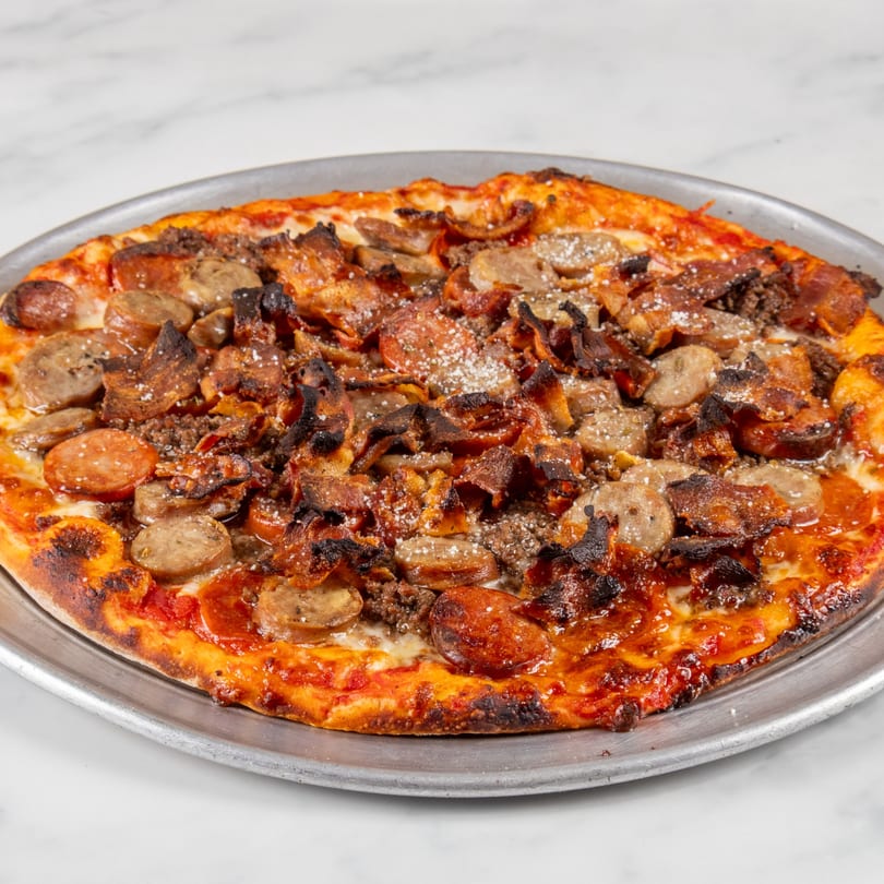 A North End Market & Deli meat lovers pizza, topped with sausage, pepperoni, bacon, and ground beef.